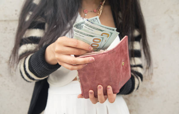 istock Woman hands with wallet and money. 1397912432