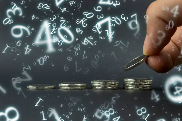 numerology, hand puts coins, in a row in ascending order, against a dark background surrounded by numbers