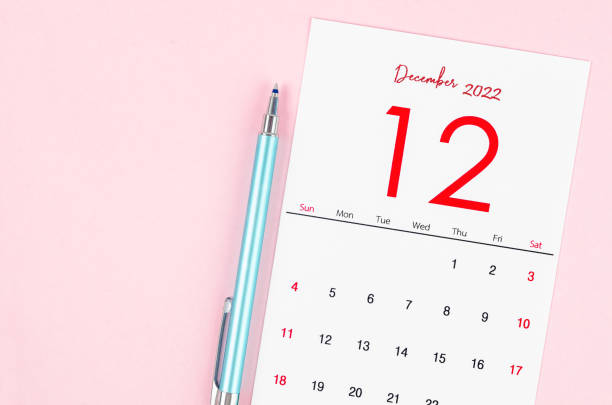 istock December 2022 calendar with pen on pink background. 1397912668