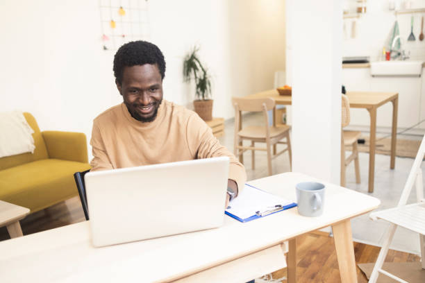 istock Happy African American working online from his home office 1397912687