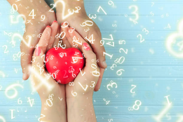 numerology, a heart in the hands of a girl in male hands, surrounded by numbers, the concept of love numerology, a heart in the hands of a girl in male hands, surrounded by numbers, the concept of love kurma stock pictures, royalty-free photos & images