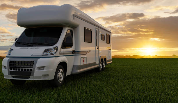 a camper van is parked on a grassy area
