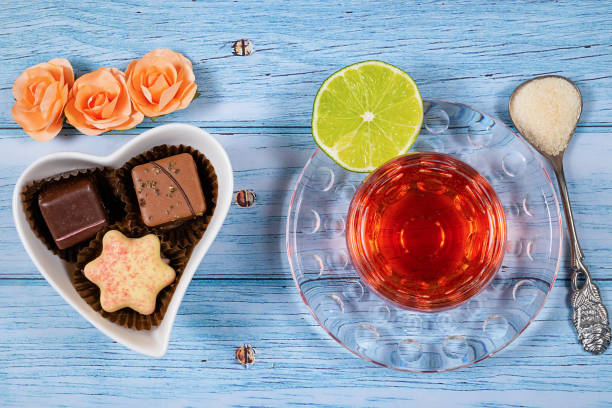 A cup of tea and chocolate candies. stock photo
