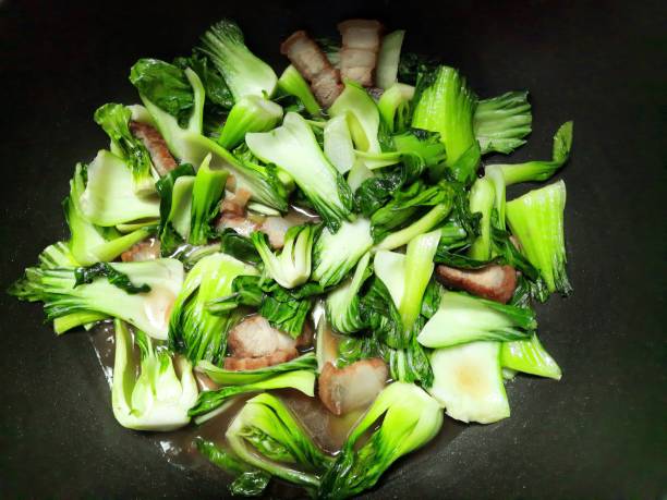 Stir fried Bok Choy with Pork Belly - food preparation. stock photo