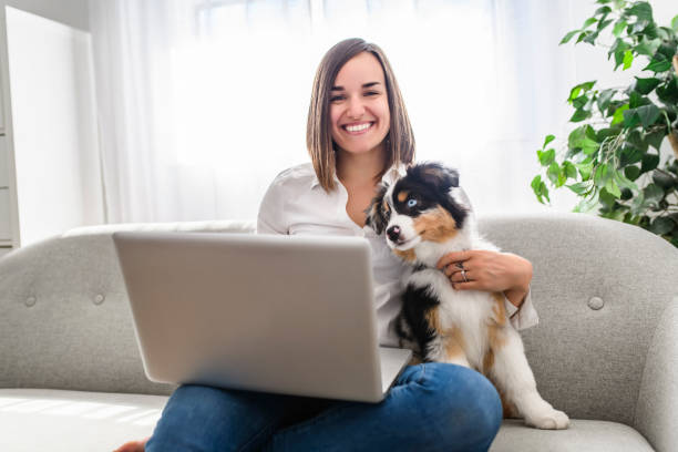 istock Handsome female with her Australian Berger puppy on sofa 1397918174