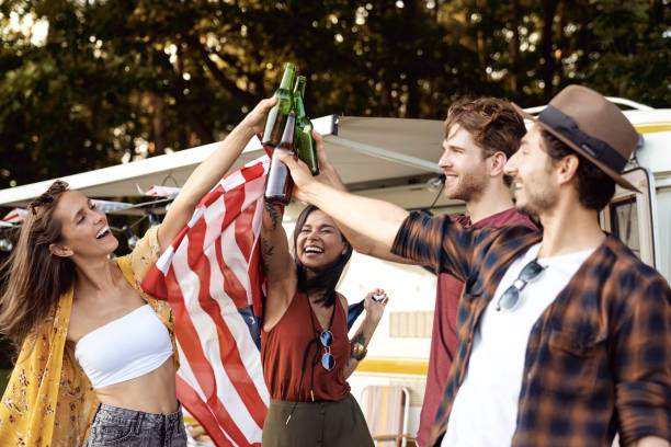 istock Carefree Friends Toasting Bottles At Park 1397920209