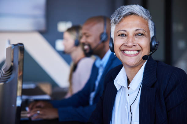 istock Smiling mature female customer service representative wearing a headset working in an office 1397921788