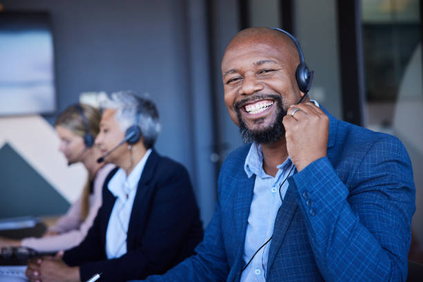 istock Smiling mature male customer service representative wearing a headset working in an office 1397921905