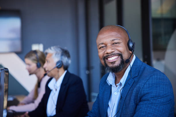 istock Mature male customer service representative smiling while wearing a headset in an office 1397921953