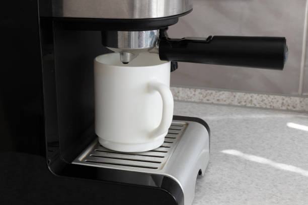 istock a cup in a coffee machine. homemade coffee machine in the kitchen. close-up 1397922462