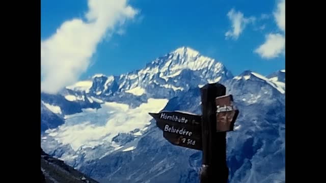 person looking at signs in the mountains in Valais in the 1980s