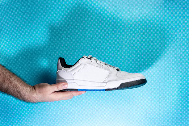 istock Tennis shoes on blue background 1397923455