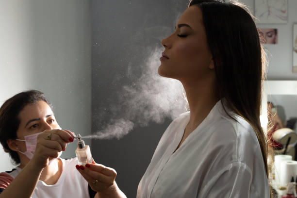 istock A makeup artist spraying a young woman's face. 1397923494