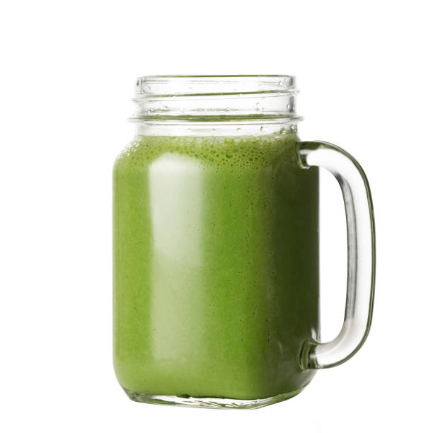 istock Green juice in mason jar on white background. 1397923625