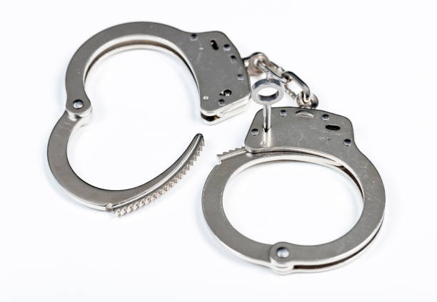 istock Police handcuffs isolated on white background 1397923809