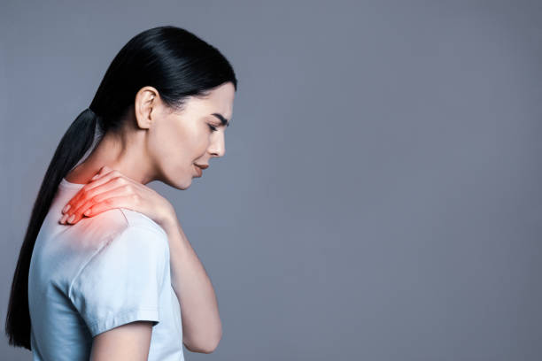 istock Woman suffering from shoulder pain on grey background. Space for text 1397925099