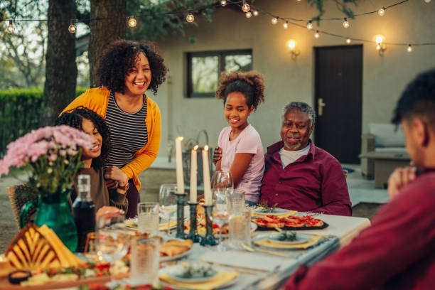 istock Affectionate family enjoying dinner during their get together in the backyard 1397927083