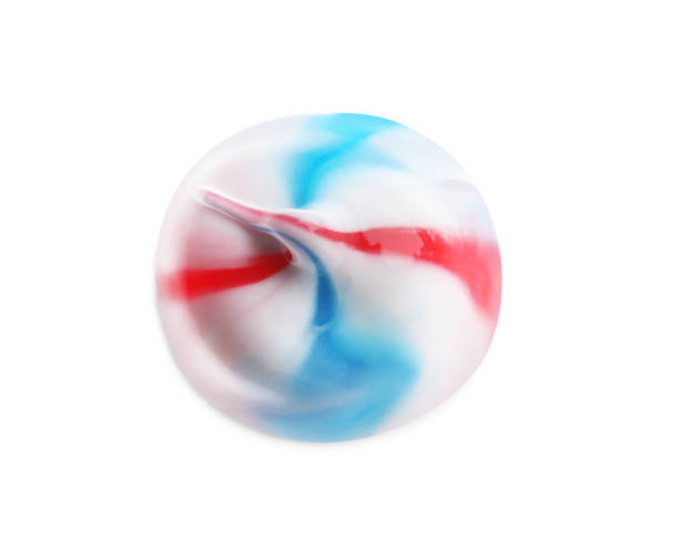 istock Smear of colorful toothpaste isolated on white, top view 1397927368