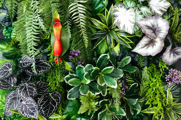 istock Seamless pattern with artificial tropical leaves and flowers on dark background. Tropic rain forest foliage texture. 1397927372