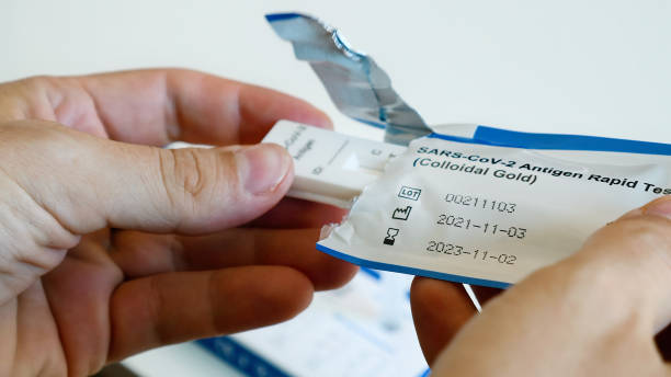 istock Man hands open sterile package with coronavirus antigen test for self diagnosis 1397927894