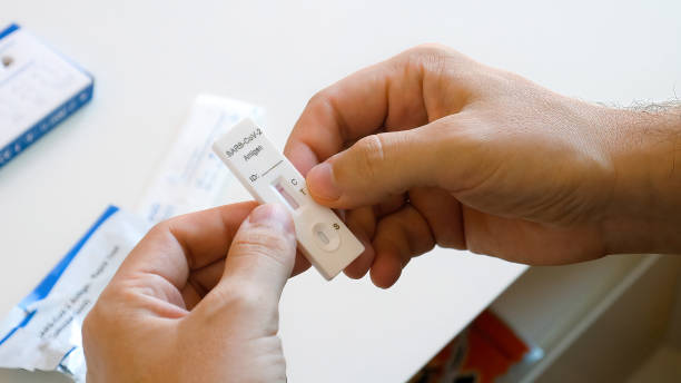 istock Man in face mask with self testing negative covid test. Covid-19 self-test 1397927901