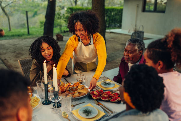 istock Multi-generation family having dinner outdoors in the backyard 1397928013