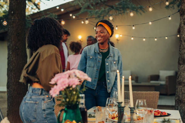 istock Two female friends preparing dining table for dinner party at backyard 1397928812