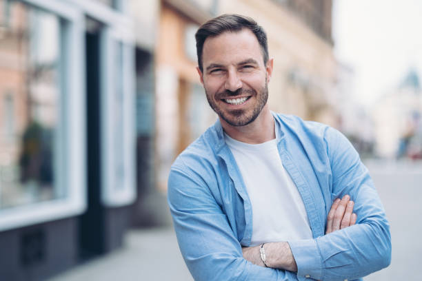 istock Smiling man outdoors in the city 1397929614