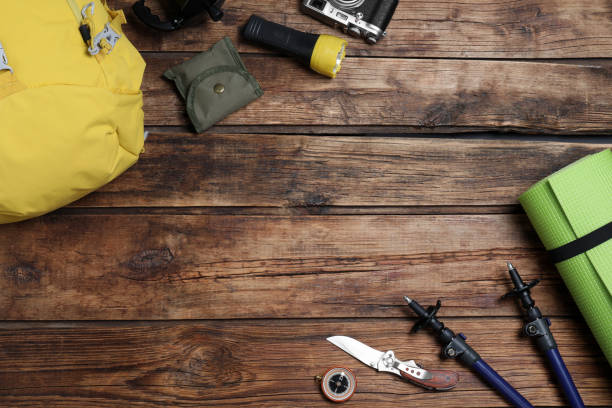 istock Flat lay composition with tourist backpack and other camping equipment on wooden background, space for text 1397929702