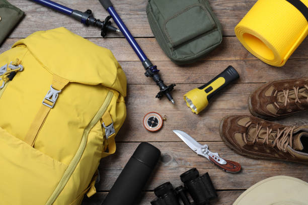 istock Flat lay composition with backpack and other different camping equipment for tourism on wooden background 1397930249