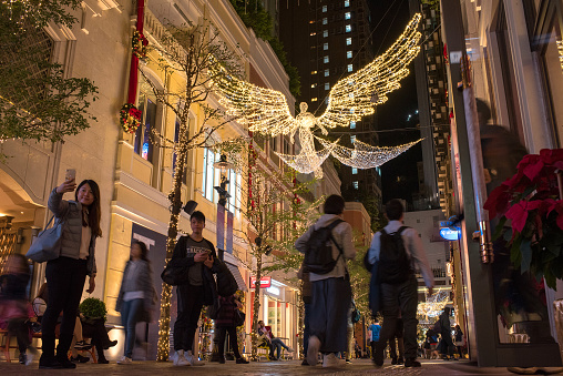 Hong Kong Island, Hong Kong - December 9, 2018: People enjoying Christmas lights at night in Lee Tung Avenue.