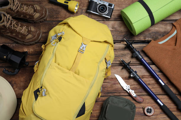 istock Flat lay composition with backpack and other different camping equipment for tourism on wooden background 1397930735