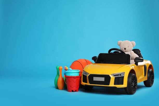 istock Child's electric car with other toys on light blue background. Space for text 1397930785