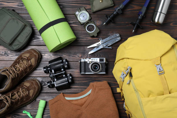 istock Flat lay composition with backpack and other camping equipment for tourism on wooden background 1397930980