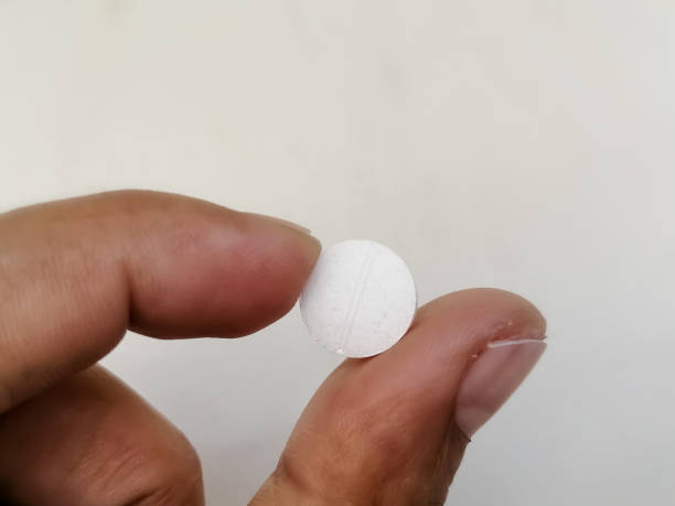 istock Hand holding pharmaceutical medicine pill or tablet with white background. 1397932048