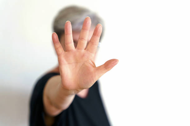 A woman protects herself with defensive hand movement
