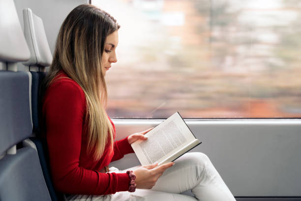 istock Girl Reading Book in Train 1397932489