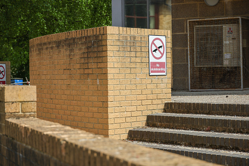 'No Skateboarding' waring sign on stone steps