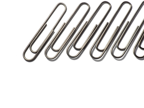 Metal paper clips on a white background. office supplies isolate\