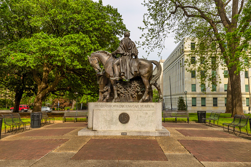 Raleigh, North Carolina, USA - May 1, 2022:  State Capital of North Carolina seeing the back side of the Statues of three, showing Andrew Johnson on the horse, all North Carolinians that became presidents of the United States.
