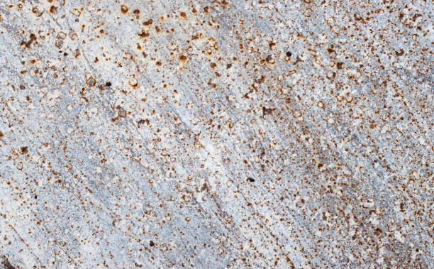 istock Scattered rust and spot textures on a damaged old metal sheet 1397935935