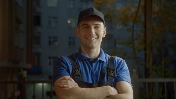 istock Attractive young delivery man courier in blue cap put your hands together and smiling into camera. Profession concept. 1397936239