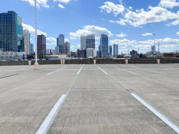 Empty parking lot in front of a cityscape