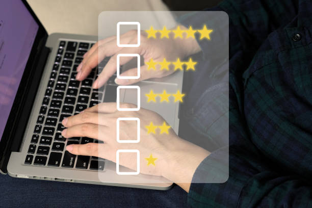 istock Man using a laptop computer to review customer satisfaction on the internet website. 1397938968