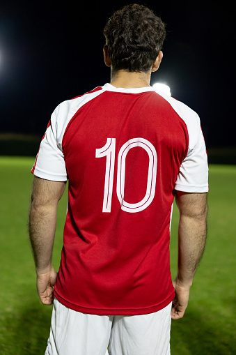 Rear view of a Number 10 soccer player with ready to enter the field to play the game - substitution concepts