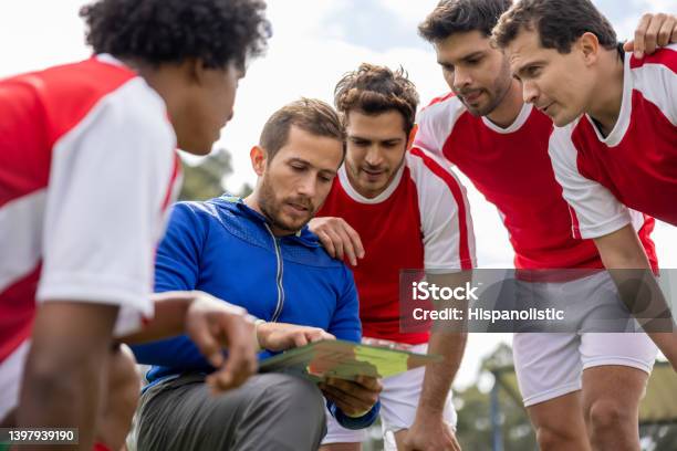 Soccer Coach Talking To His Team About Their Strategy For The Game Stock Photo - Download Image Now