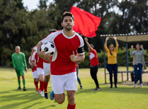 Soccer players entering the field in line behind the team captain Latin American soccer players entering the field in line behind the team captain - sports concepts soccer team captain stock pictures, royalty-free photos & images