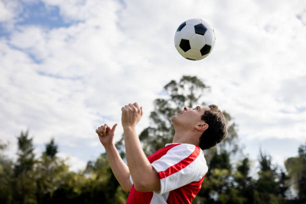 Latin American Soccer player heading the ball while playing a game - sports concepts