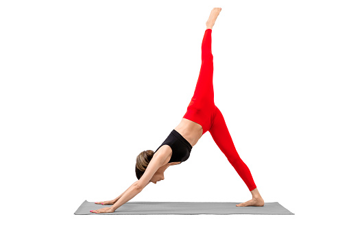 Adho mukha svanasana, yoga. Attractive slim woman practice three-legged downward facing dog pose, isolated on white. Fitness promo, balance, sport, workout, training, stretching concept