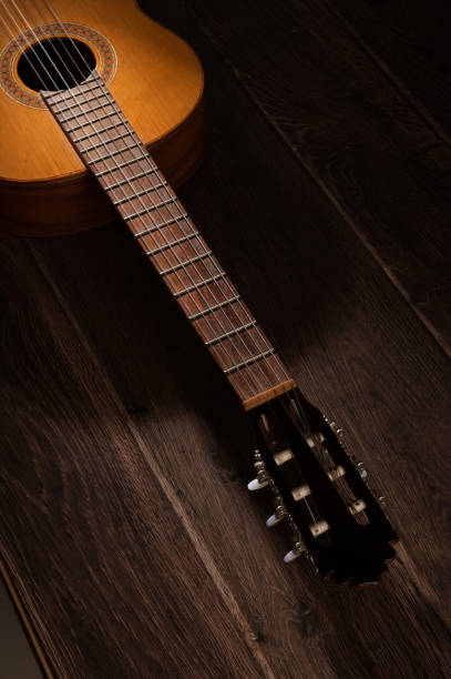 istock Classical guitar on a wood background 1397940161